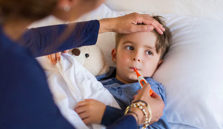 mother checking temperature of kid with thermometer