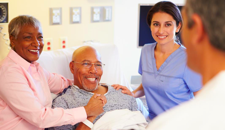 male cancer patient with wife listening to doctor and nurse