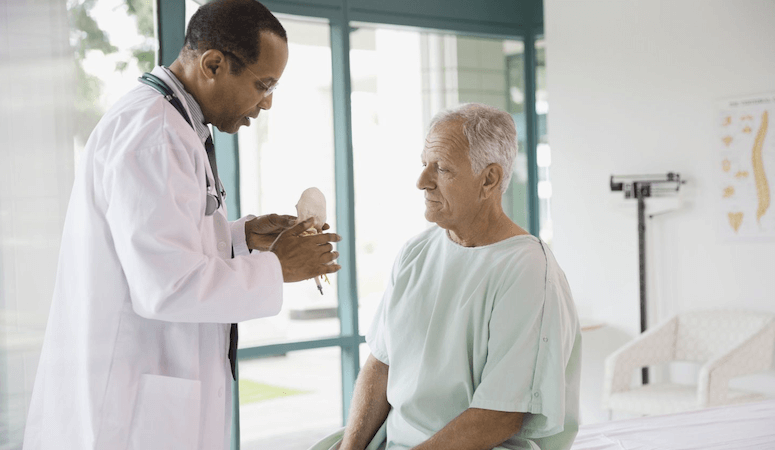doctor explaining about prostate to aged male patient
